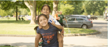 child carrying another child on her back
